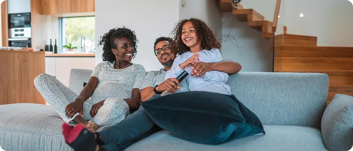 Multiracial family watching tv